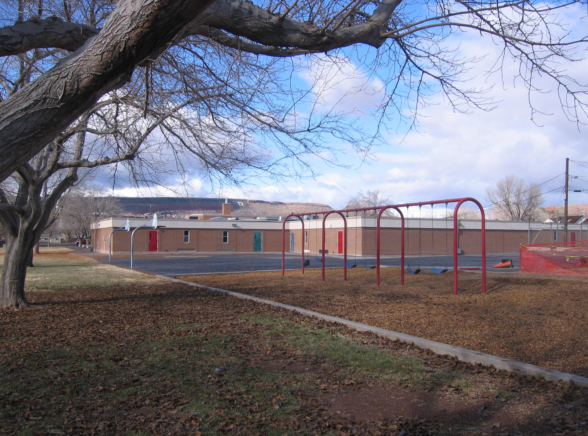Swings and basketball courts in the southeast corner of East Elementary School