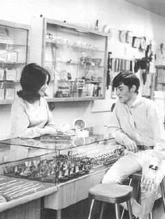 Two people at the counter in the Milne Jewelry Co. store