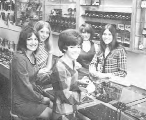 Girls at the counter of the Milne Jewelry Co. store