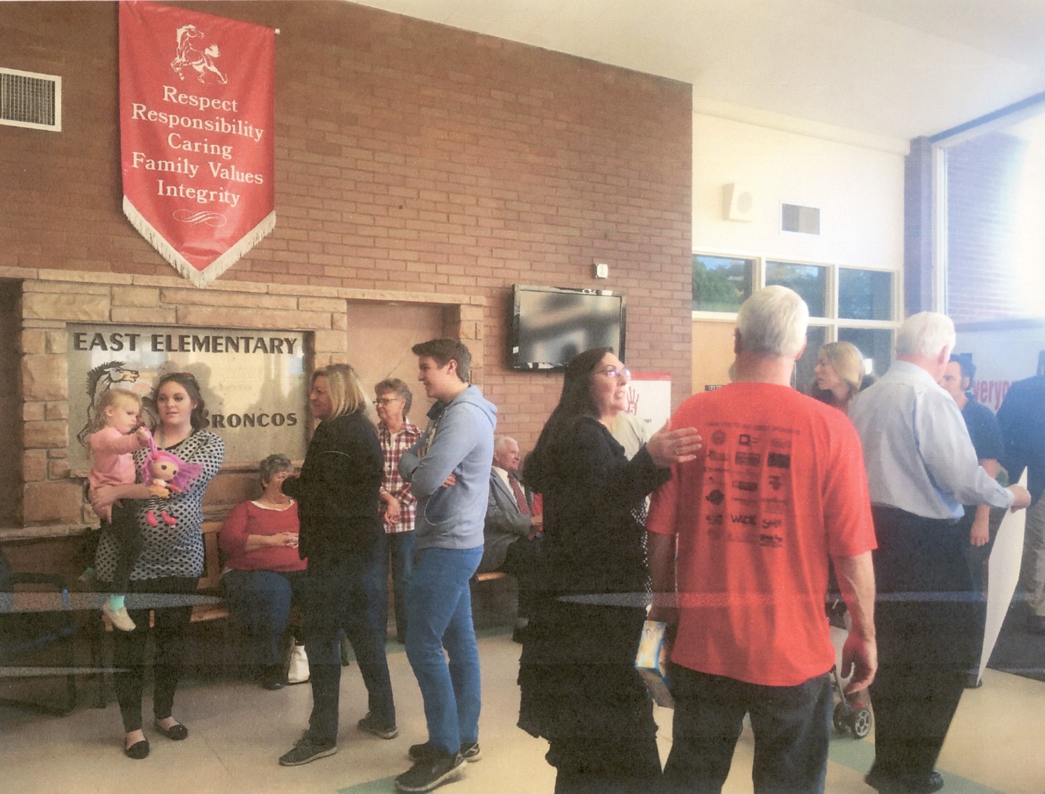 People in the foyer at East Elementary School for an open house in 2016
