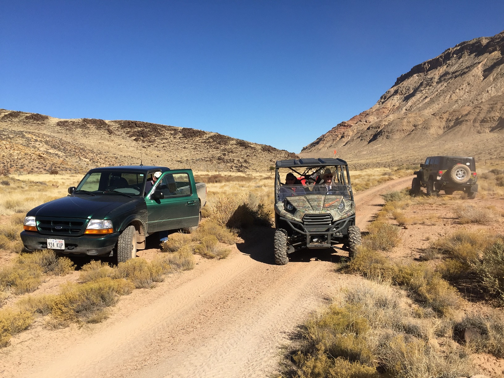 Three vehicles having just crossed the Fort Pearce Wash on the Temple Trail