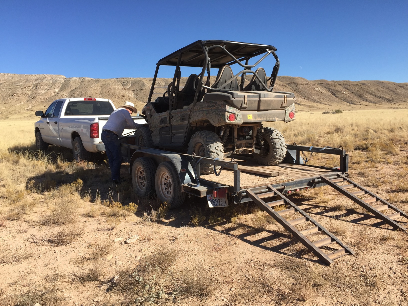 Thad Stewart finishing loading his ATV onto a trailer at the Temple & Navajo Trails