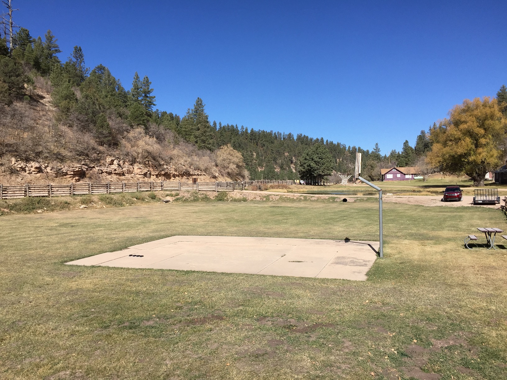 Entrance, basketball court, and pond at the Big Springs Rental Cabins