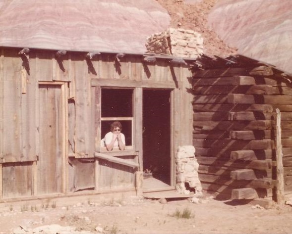 Betty Clegg in the window of a movie set building in the old ghost town of Paria, Utah