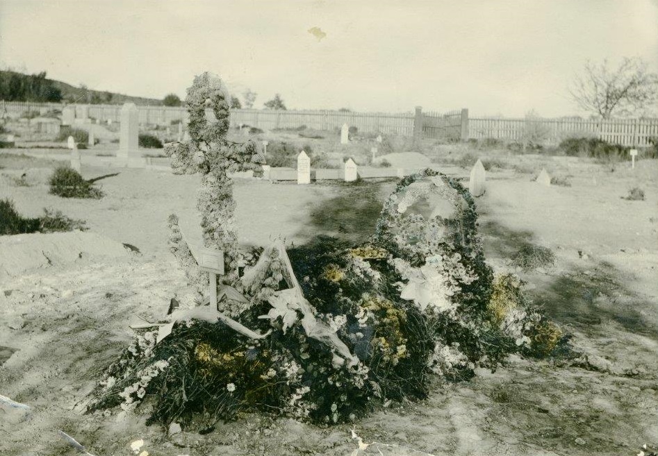 A flower covered grave in the St. George City Cemetery