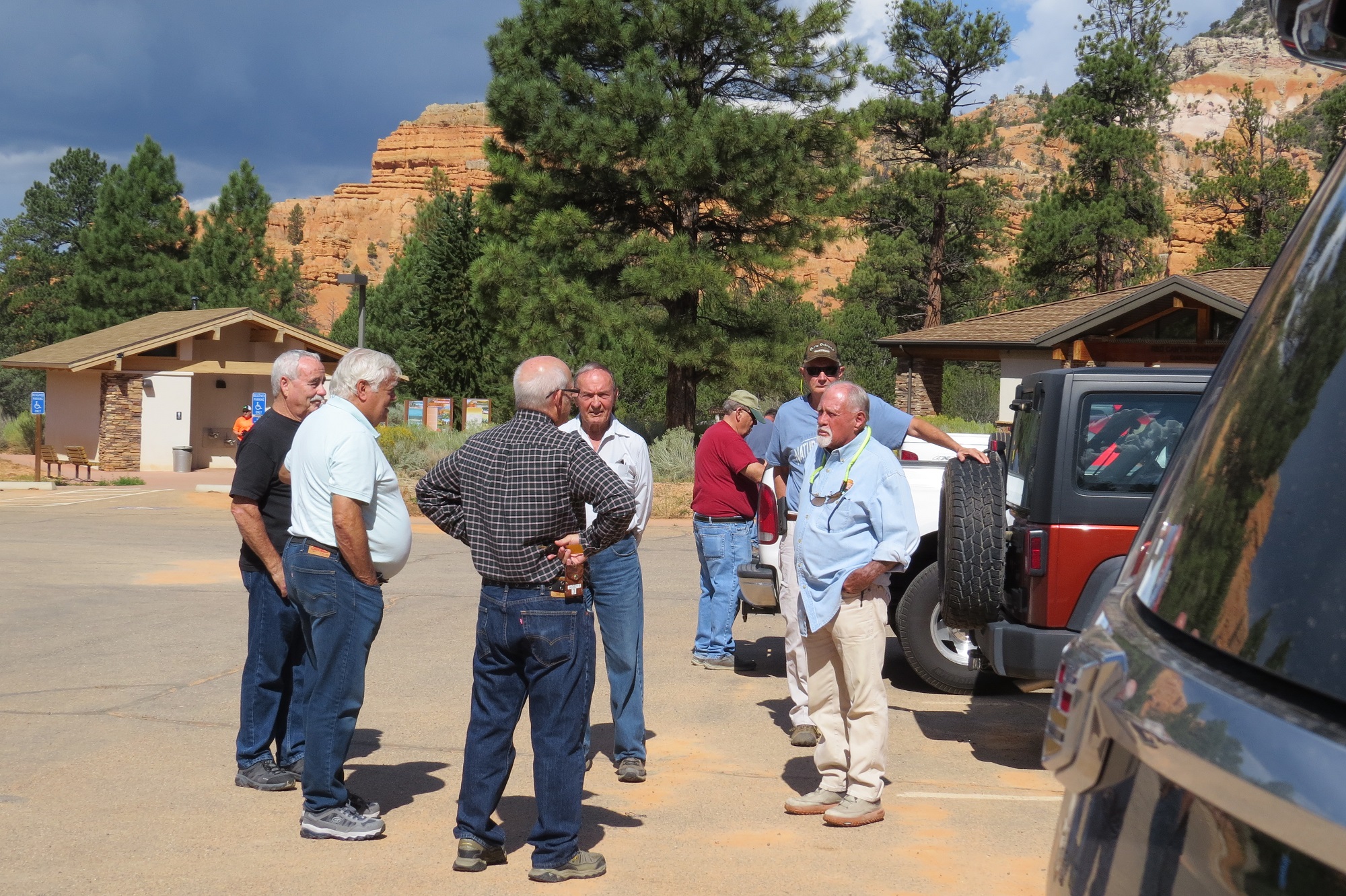 People gathered in the parking lot of the Red Canyon Visitor Center on UT Highway 12