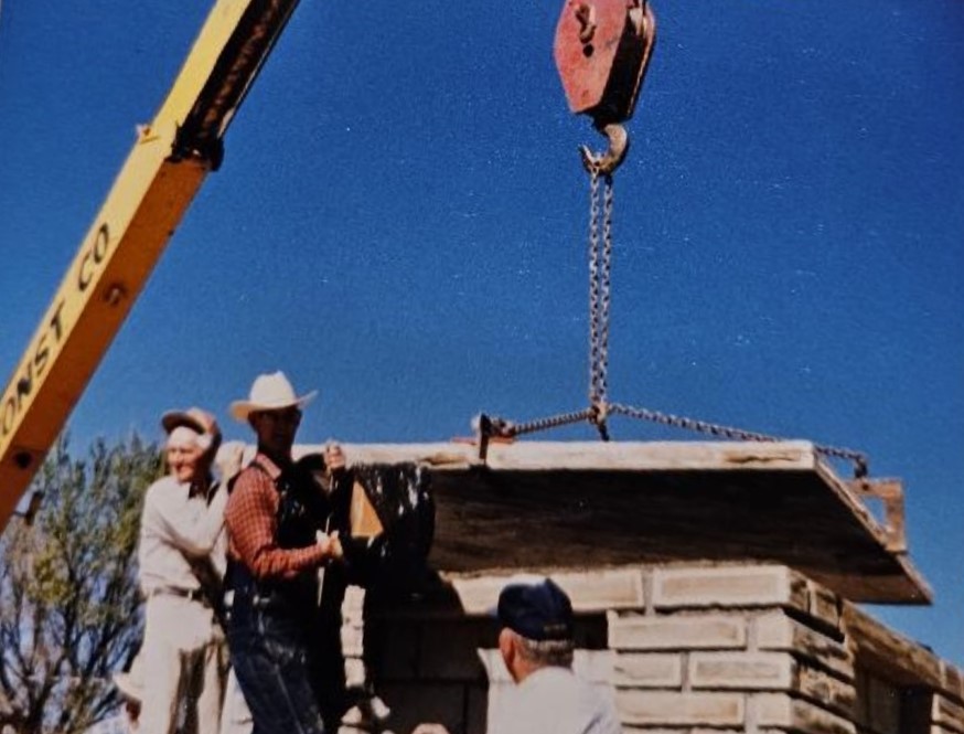 Men placing a capstone over the Hurricane 1988 Time Capsule