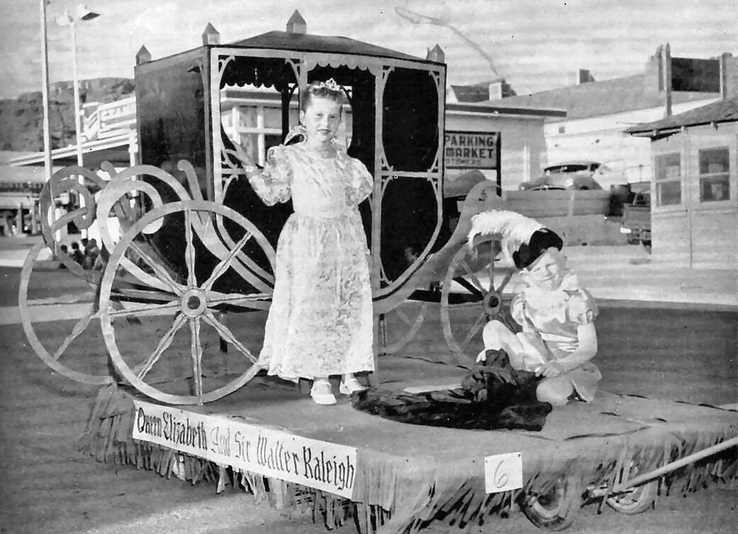 Two kids with a parade carriage on Main Street