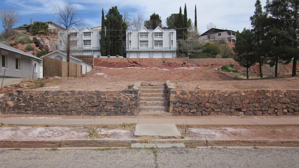Vacant lot with old rock retaining wall and steps