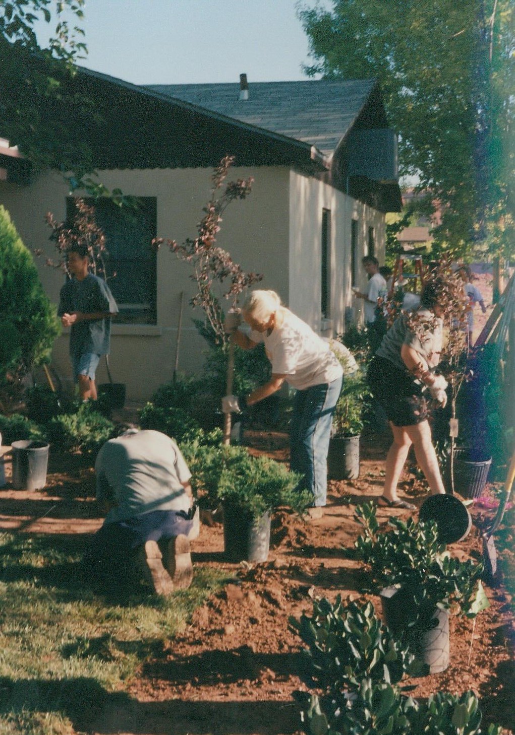 People putting in plants in front of the original Washington County Children's Justice Center