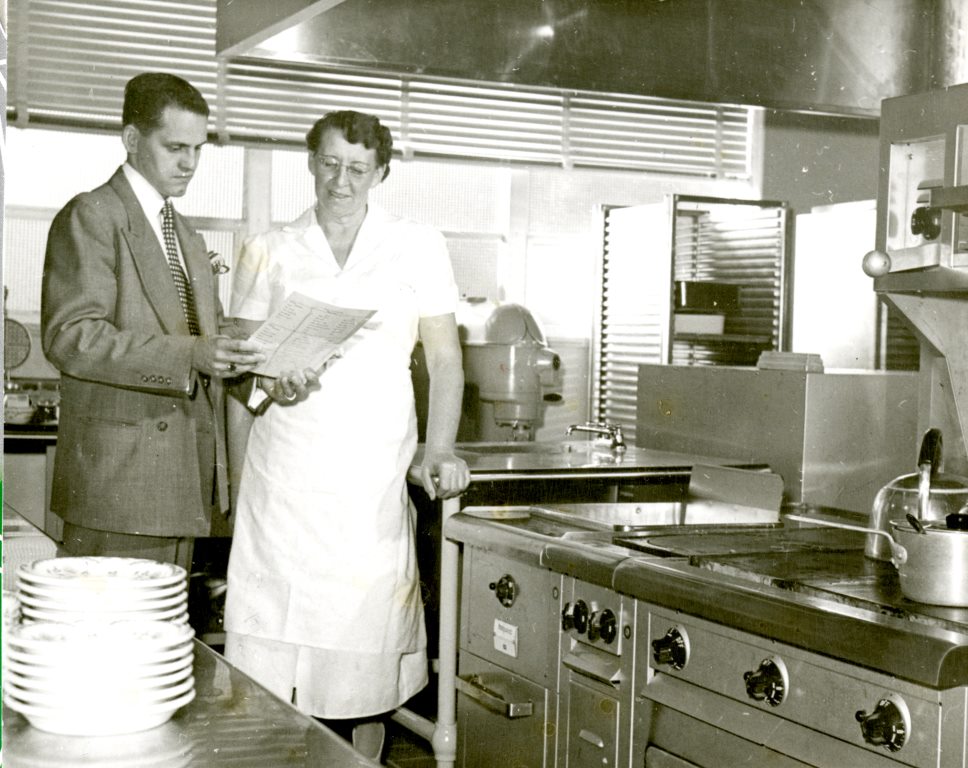Two people talking in the kitchen at the Dixie Pioneer Memorial Hospital