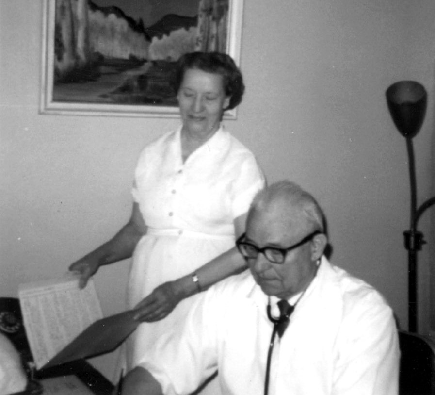 Dr. Reichmann and his nurse working in his office