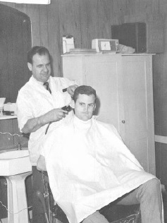 Guy getting his hair cut at the St. George Barber Shop