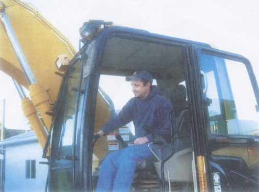 David May in the cab of a backhoe
