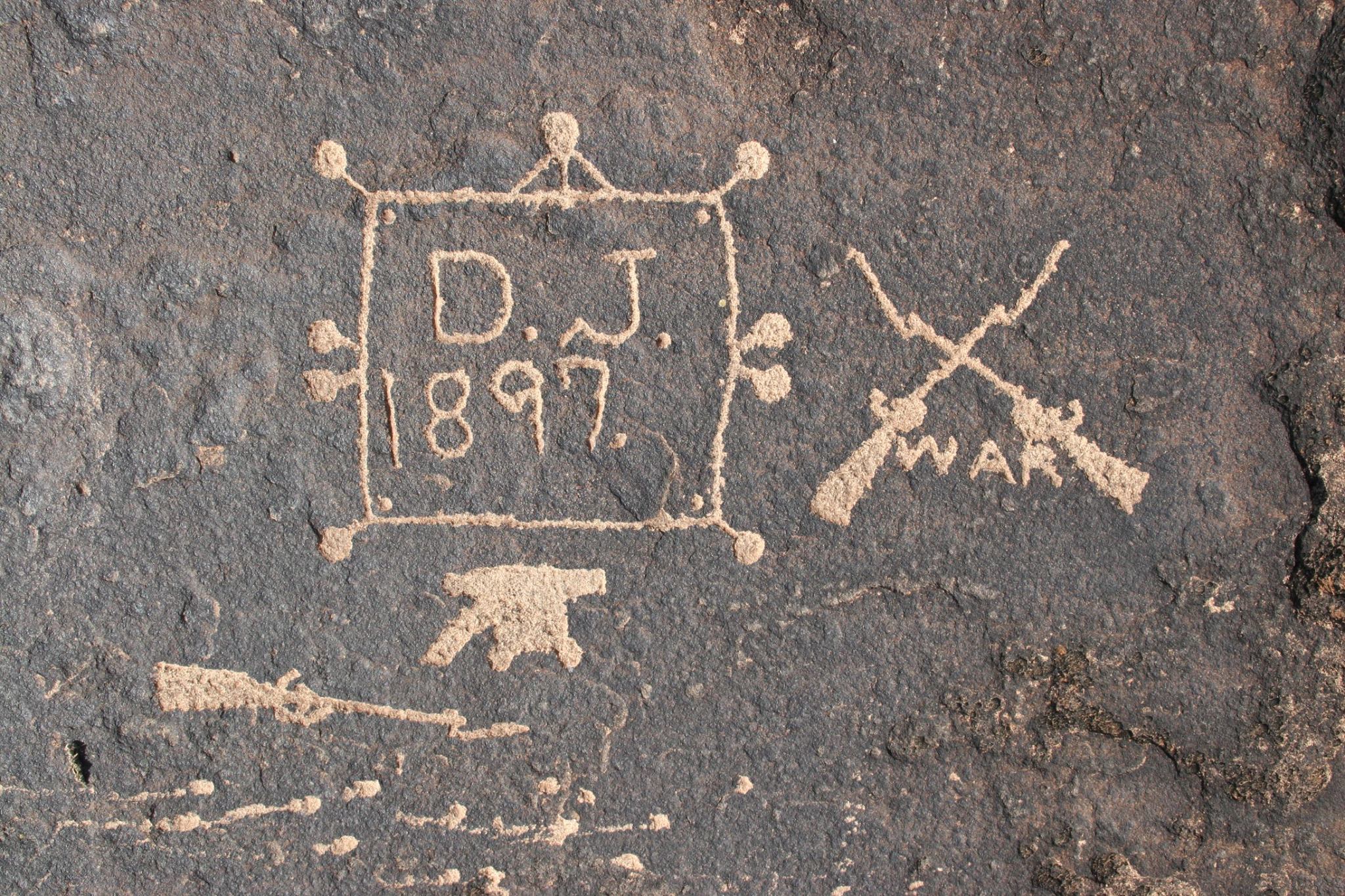 Pioneer (1897) petroglyph with various symbols of war