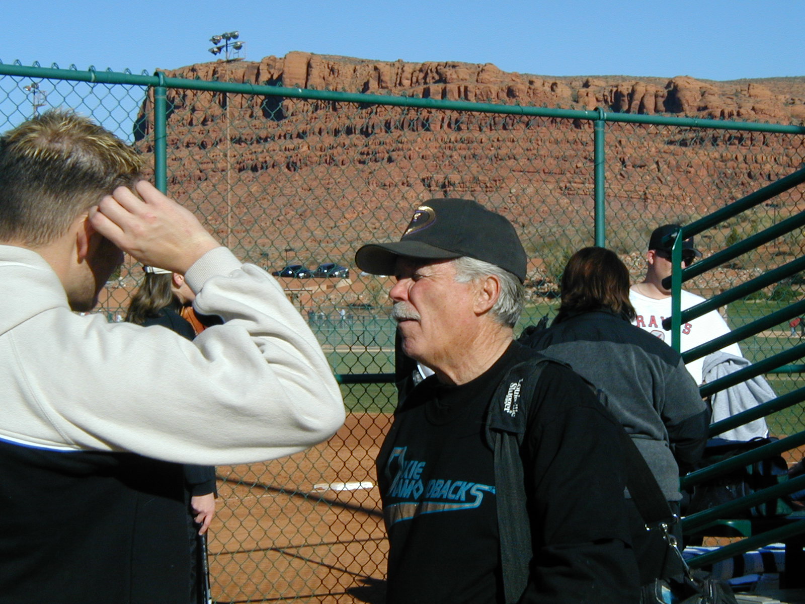 Bill Wilbur talking to someone at a ballpark