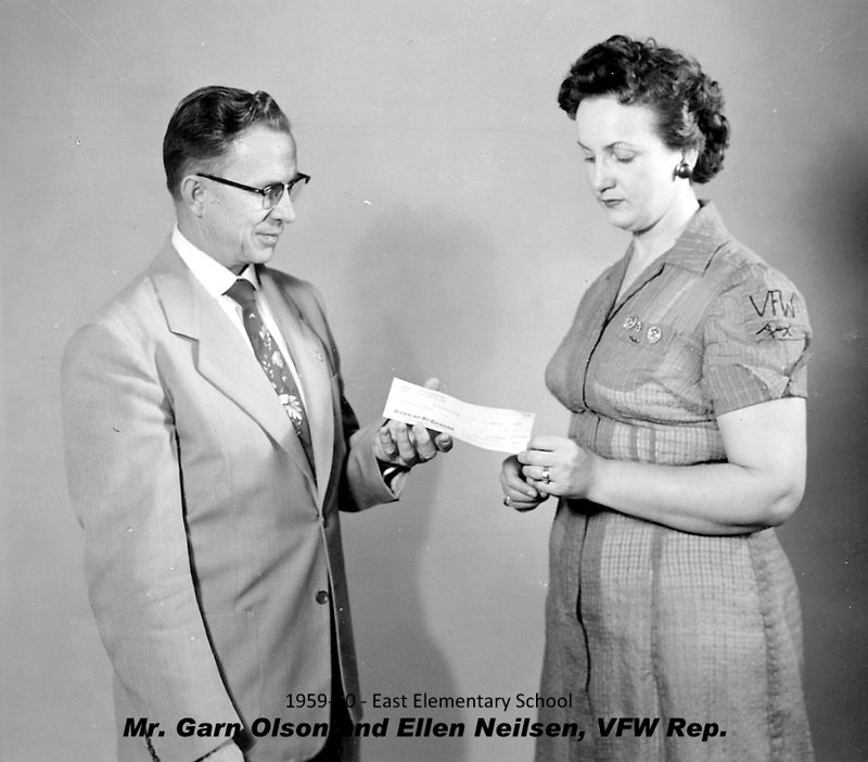 Prinicpal Garn J. Olsen receiving a check from VFW rep Ellen Neilsen