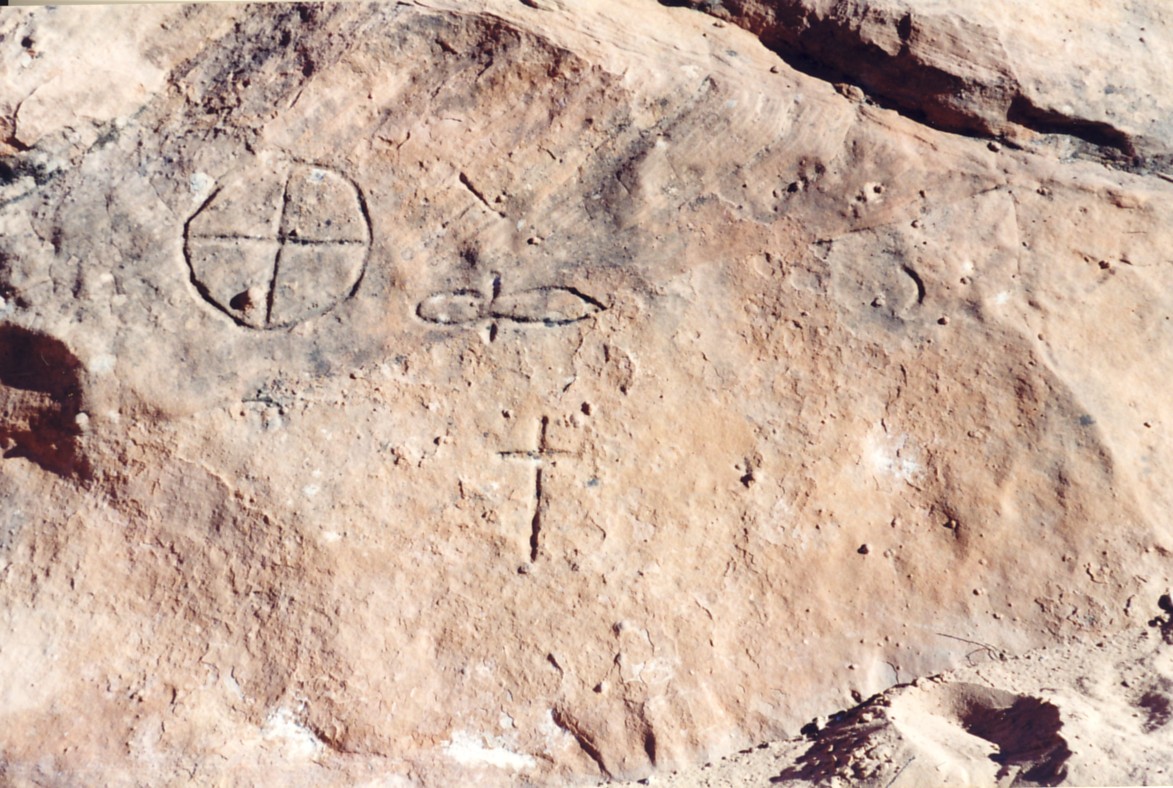 Symbols carved into a rock that look like they have been there a long time