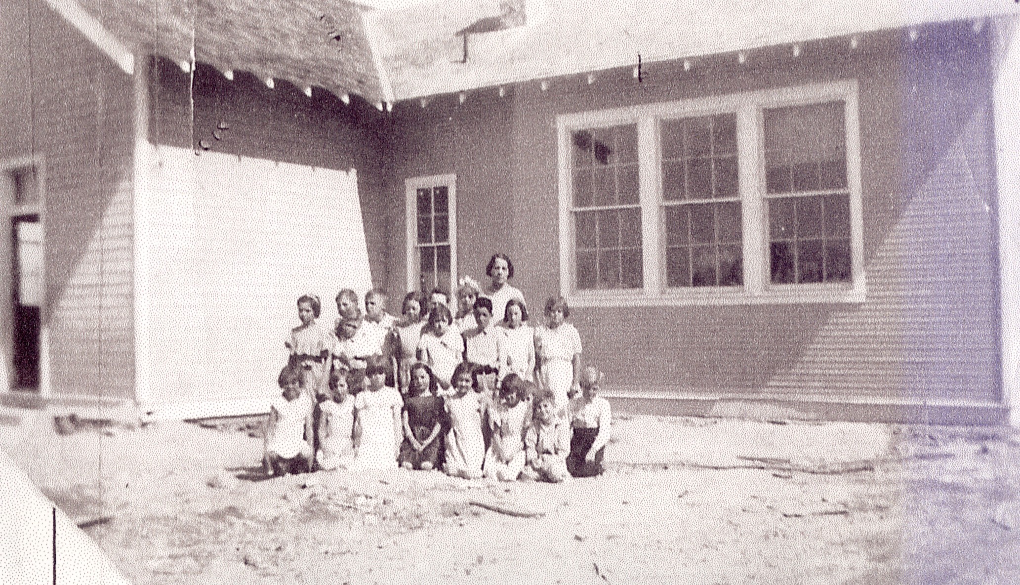 A teacher and students in back of the old Veyo school & church