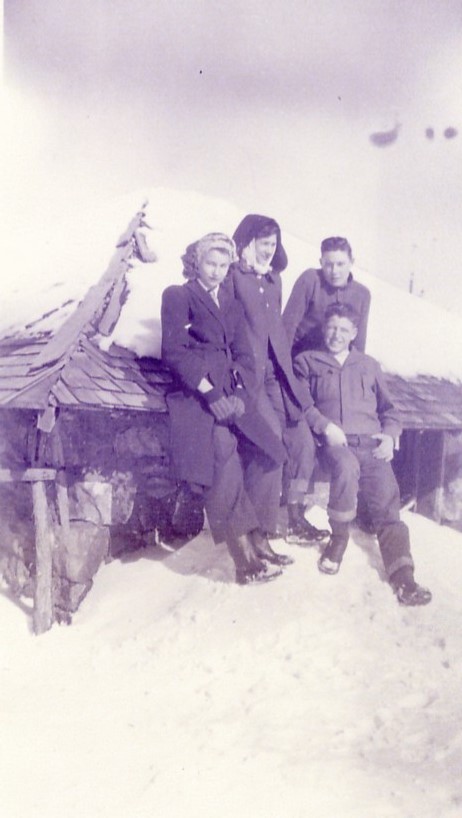 Four people in front of the Albert Bunker granary in Veyo