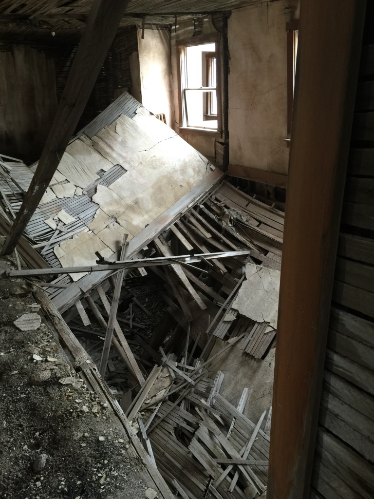 Collapsed second story floor in the ruins of the old hotel in Modena