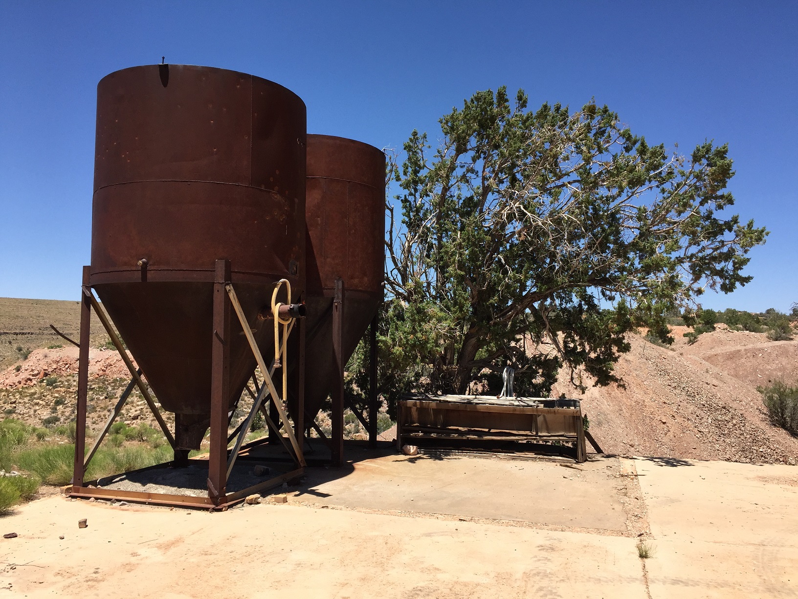 Two hoppers on a cement pad at the Grand Gulch Mine