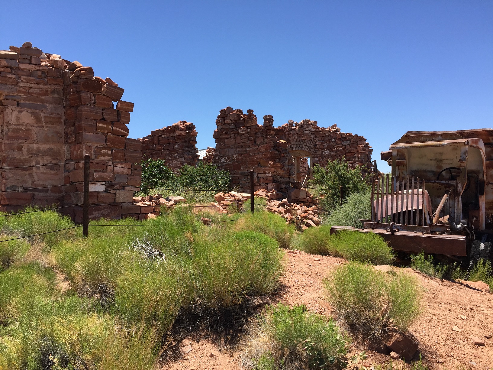 Part of the headquarters building and the front of an old truck at the Grand Gulch Mine