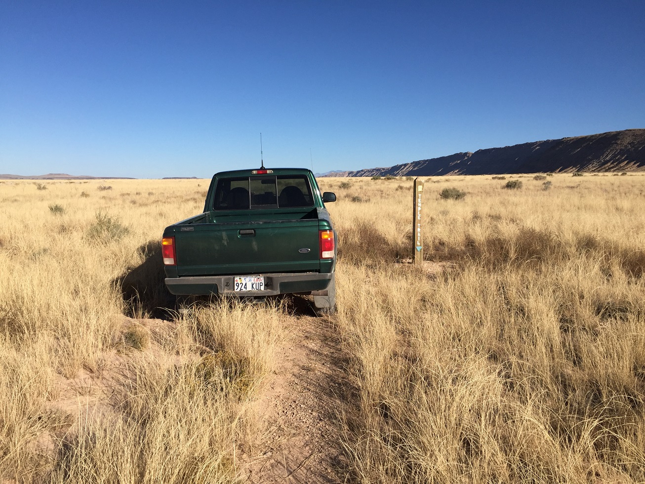 David Rogers' pickup truck on the Temple Trail along side a trail marker monument