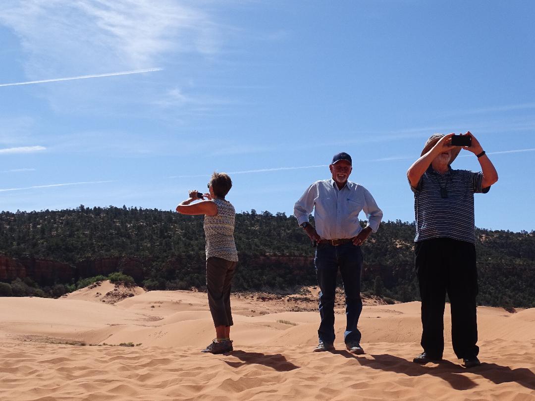 Valerie Cazier, Milt Hokanson, and George Cannon on a dune at Coral Pink Sand Dunes State Park