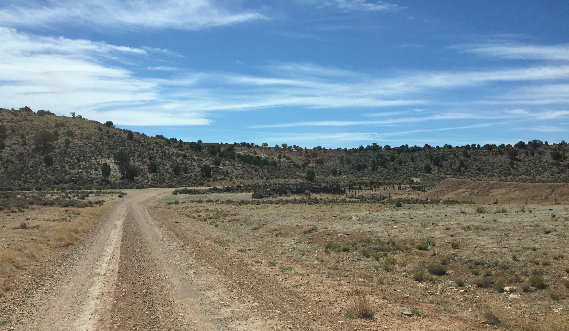 A corral and water retention pond at the intersection of two unmarked roads on the Arizona Strip