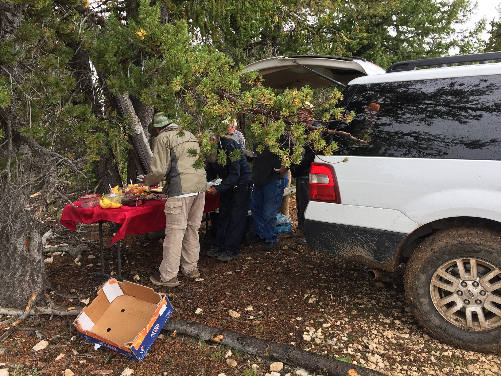 people getting lunch at the DASIA lunch buffet table at the Powell Point trailhead