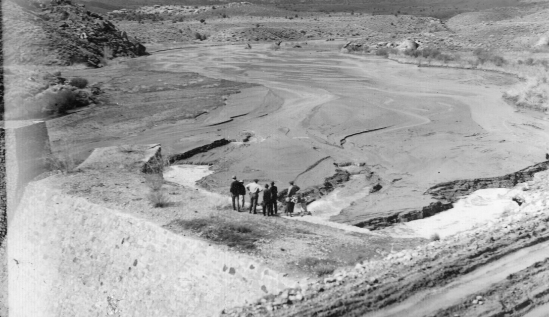 Santa Clara Irrigation Company officers attempting to flush silt from the Shem Dam reservoir