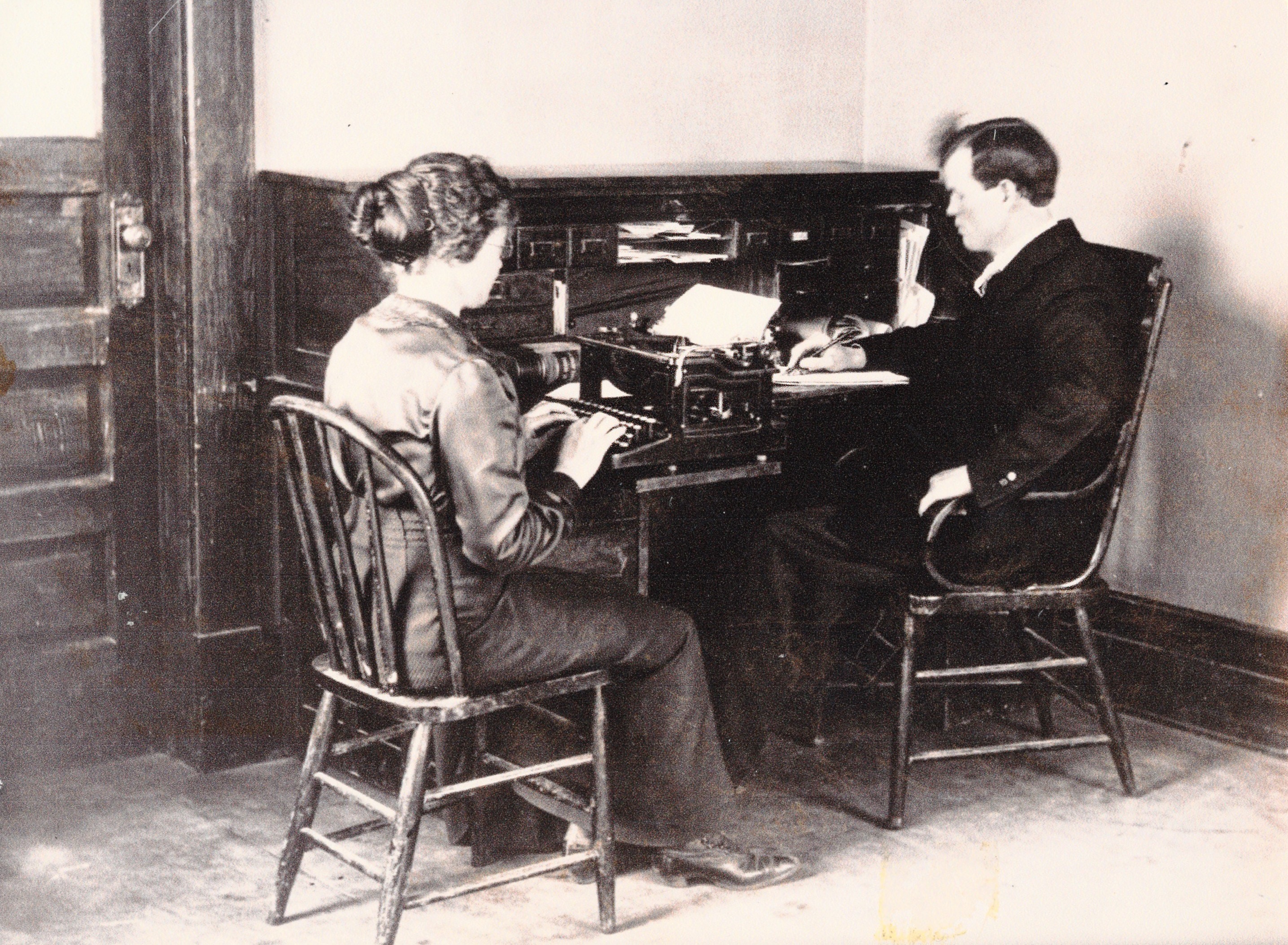 Hugh M. Woodward dictating to a secretary at the Dixie Academy