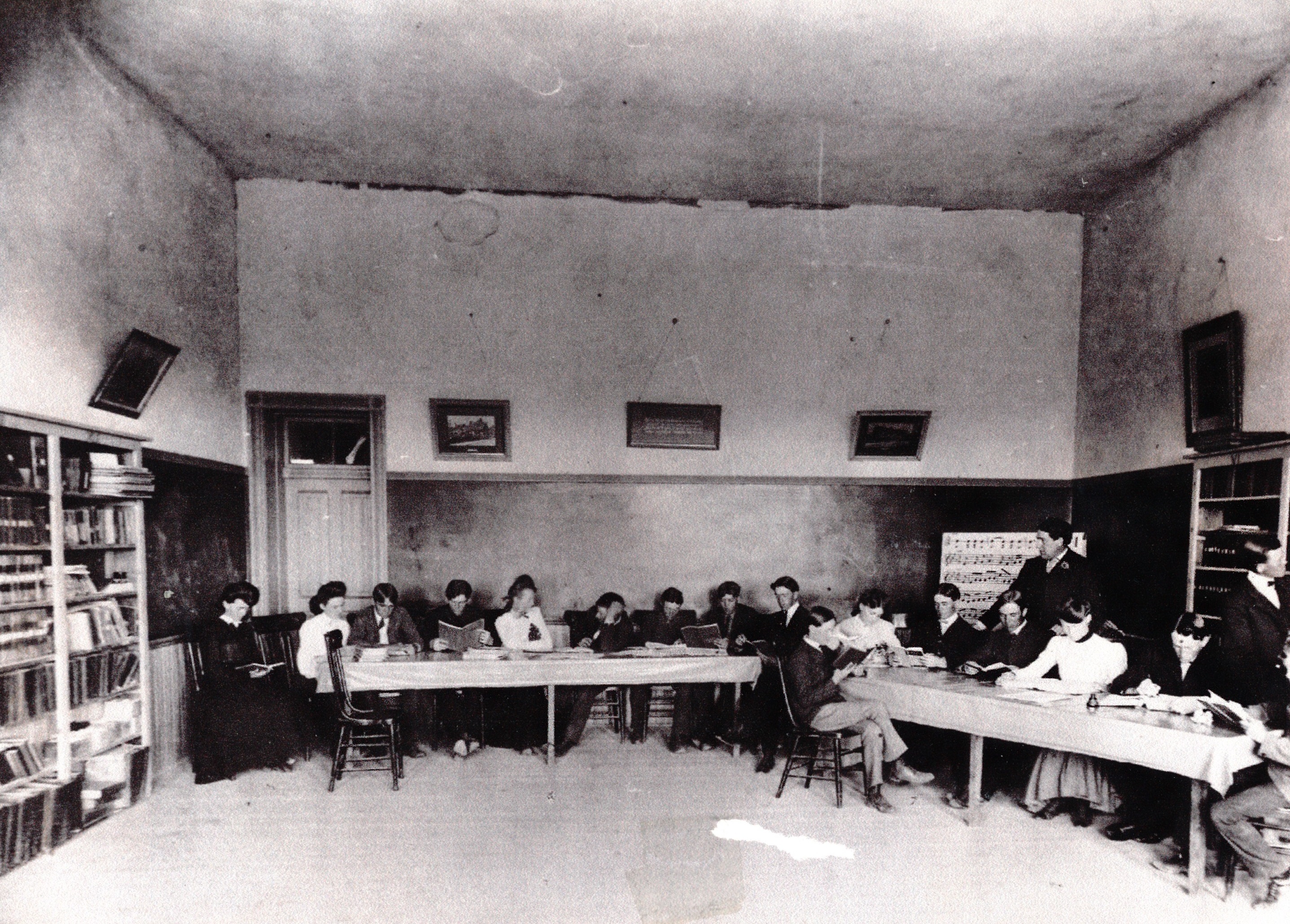 Students and a teacher in the library at the Dixie Academy Building