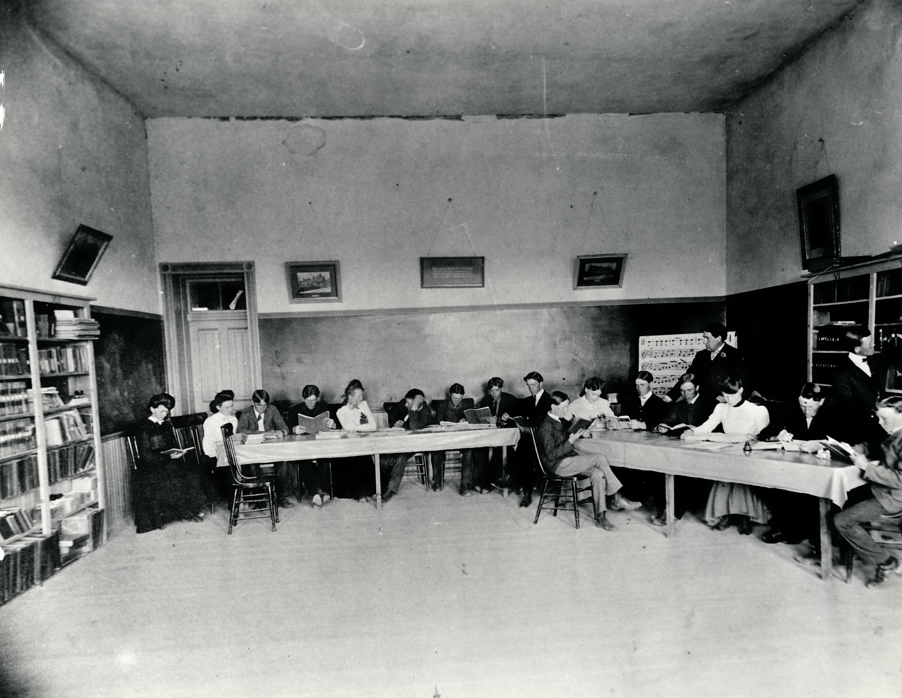 Students and a teacher in the library at the Dixie Academy Building