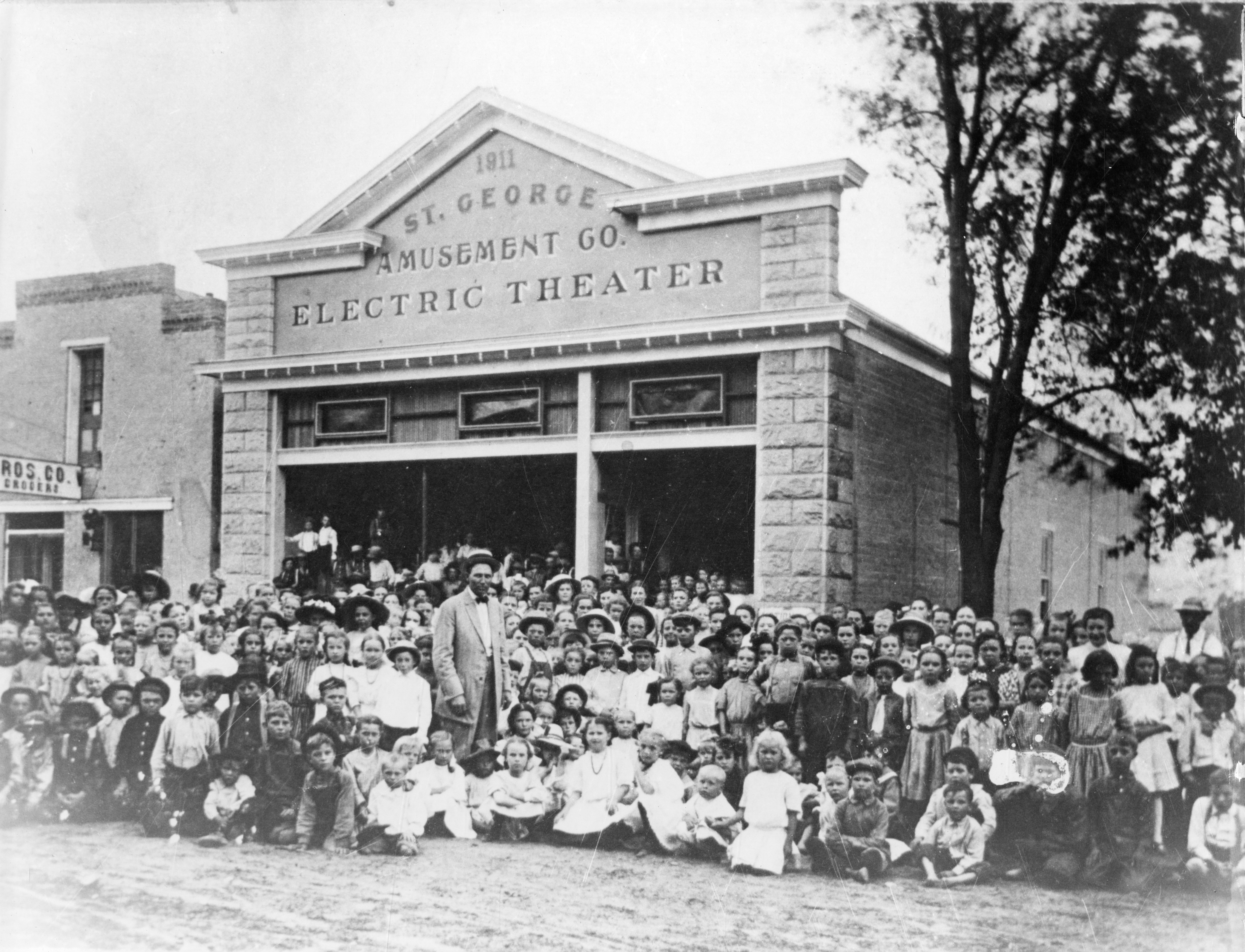 A large group of people (mostly children) out in front of the Electric Theater in St. George