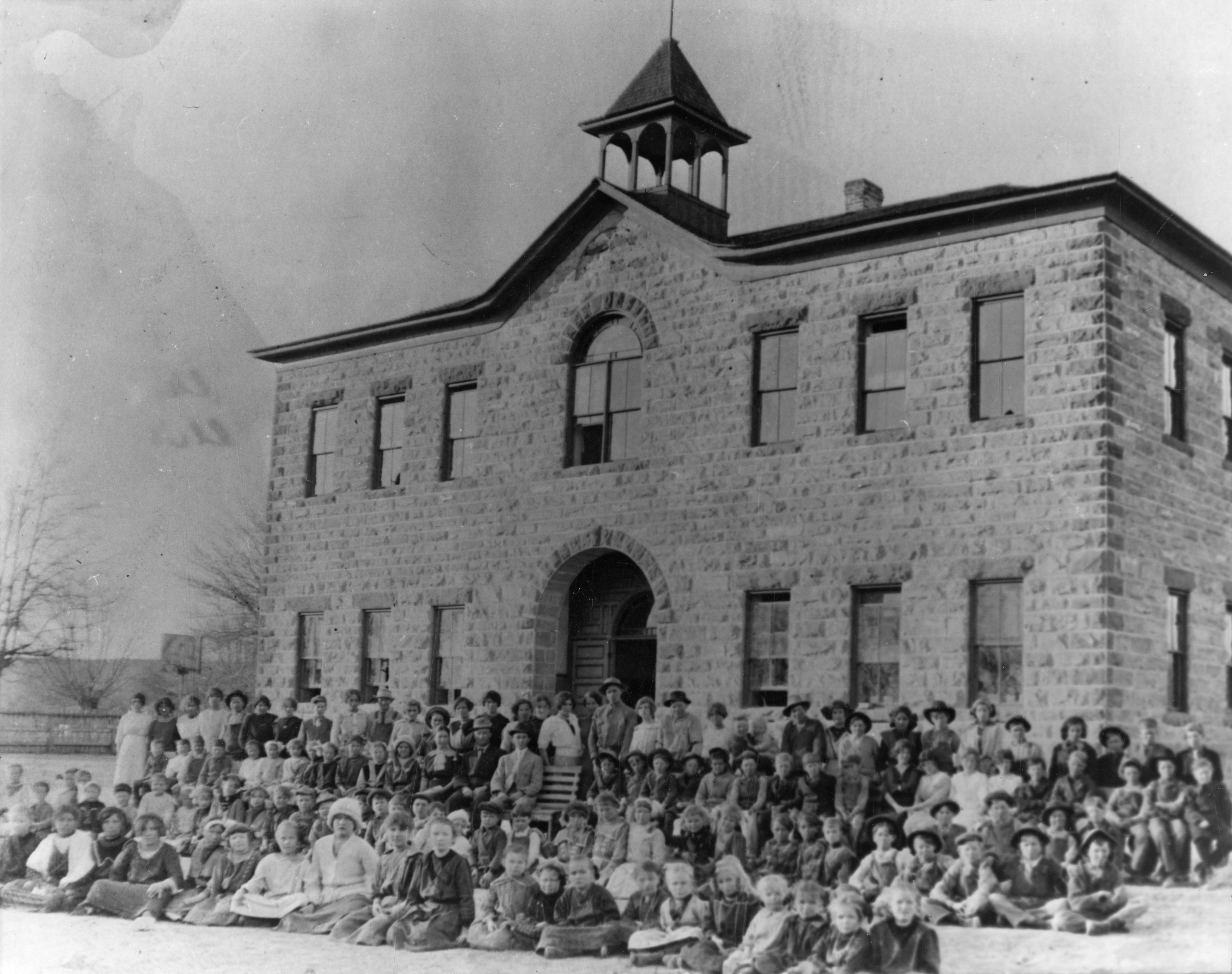 A large group of people in front of the old Washington School