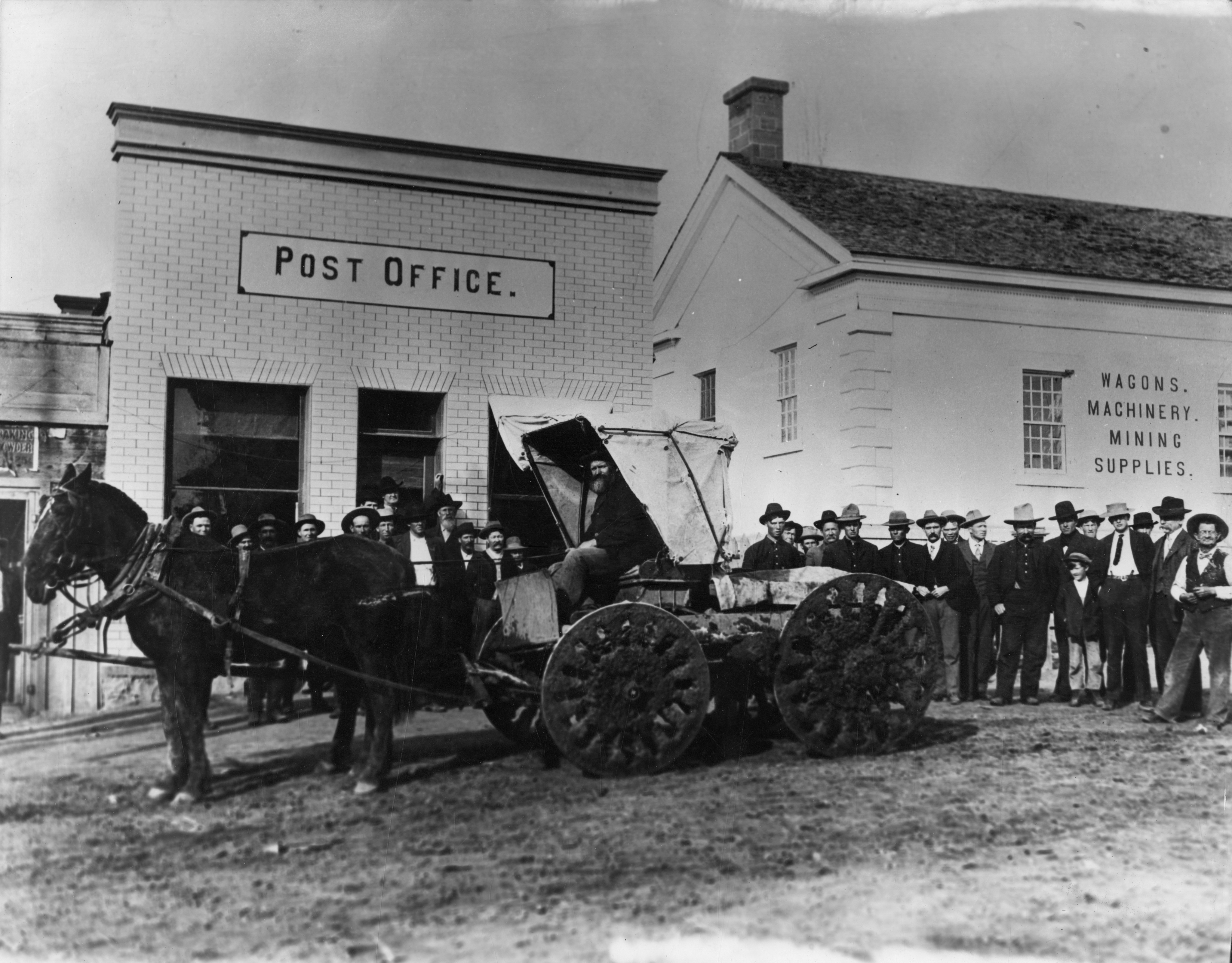 A wagon and people in front of the old Post Office on Main Street in St. George