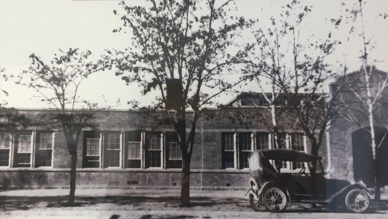 Photo of an old car in front of Hurricane's first elementary school