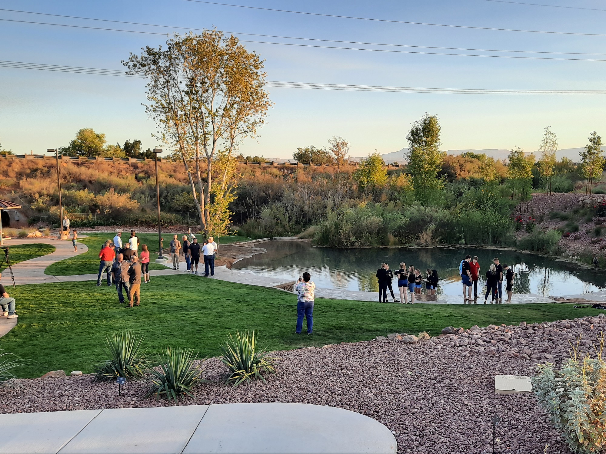 People by the pond at the Boilers Park during the opening celebration
