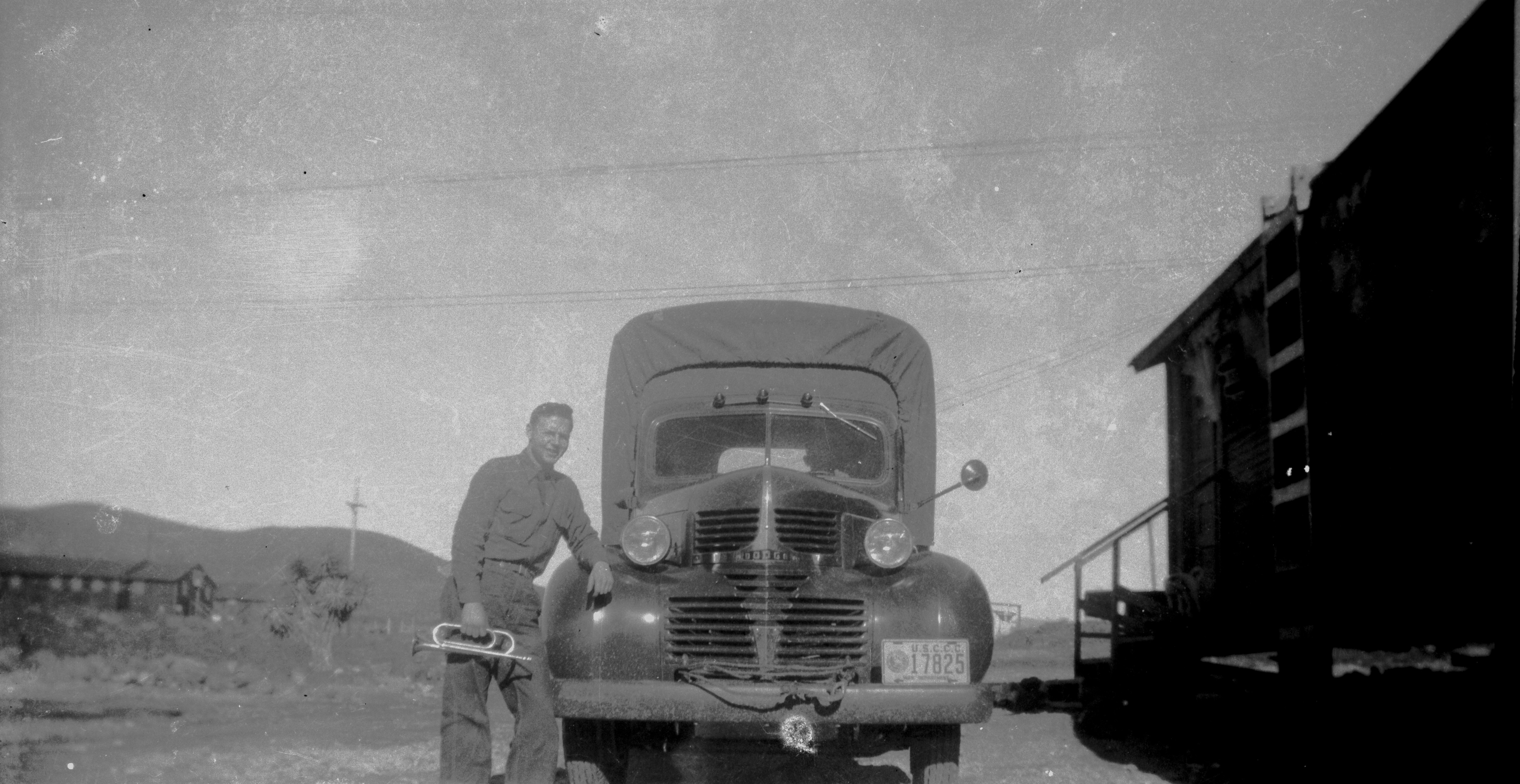 A CCC camp truck and an enrollee with a bugle
