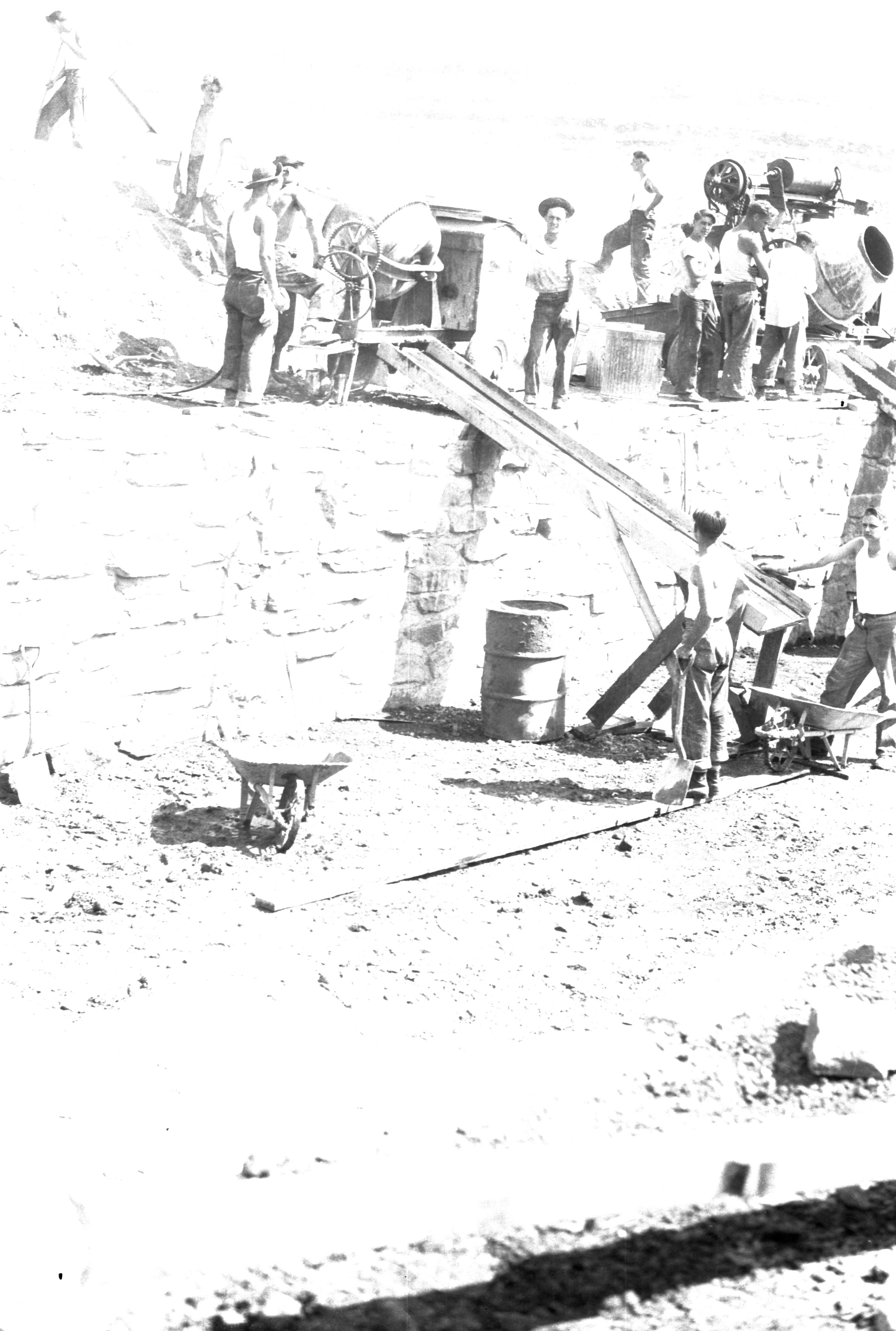 People using a cement mixer to build a swimming pool at the Leeds CCC Camp