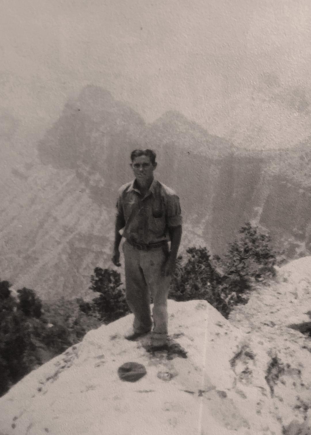 J. Russell Kimmerly from the St. George CCC Camp standing on a rock above a canyon