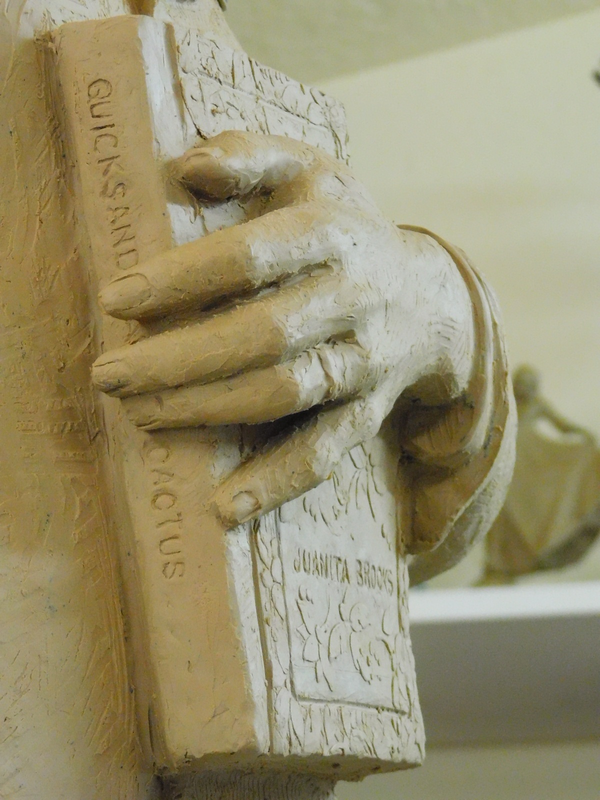 The hand & book on the clay model of the Juanita Brooks statue