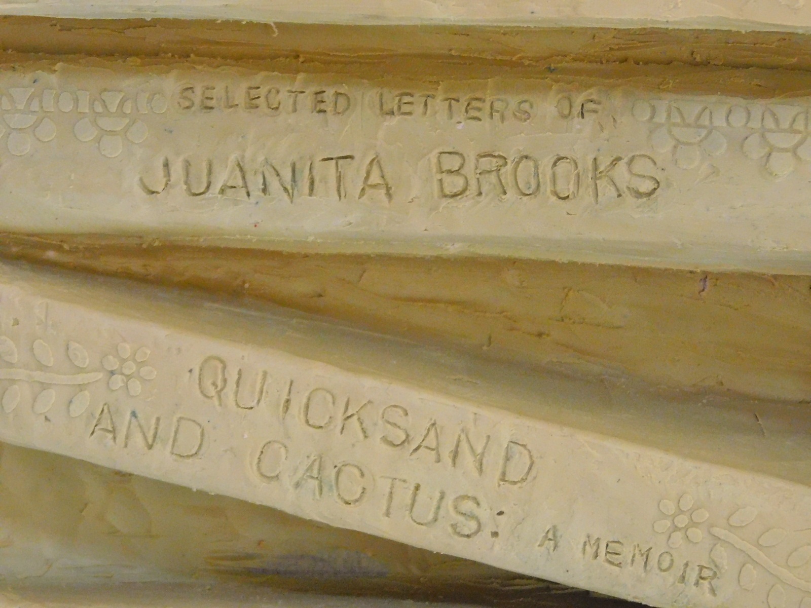 Two of the books in the book stand in the clay model of the Juanita Brooks statue