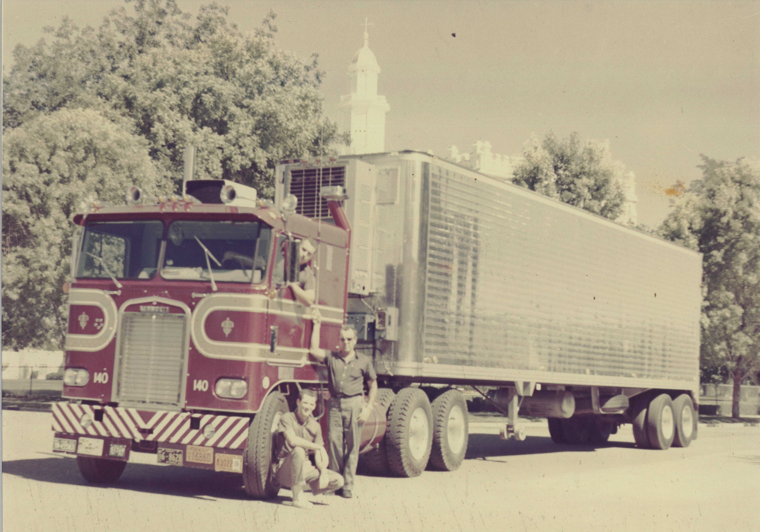 Some people with one of the old Cox Trucking trucks